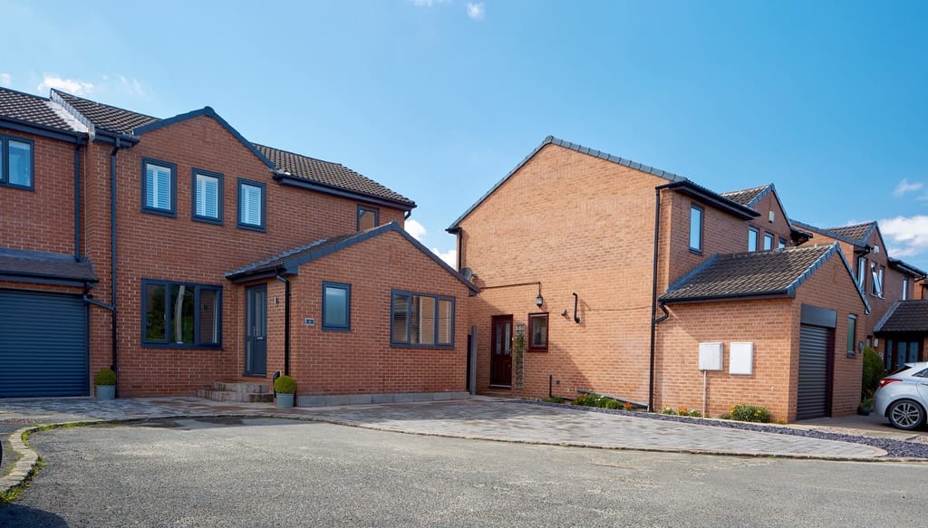 Block paved driveways and a shared turning area on a red brick cul de sac
